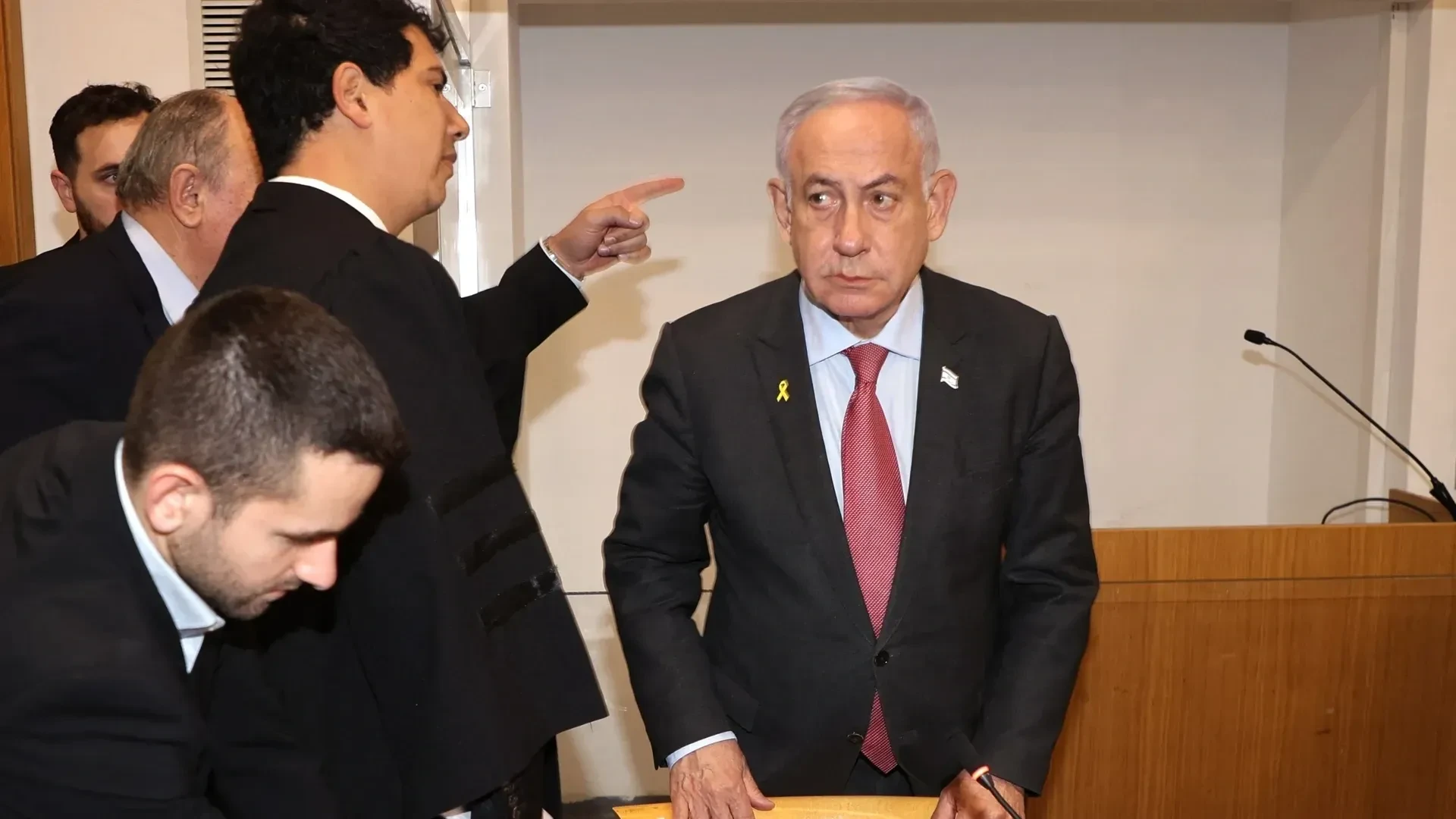 Formal meeting with men in suits discussing